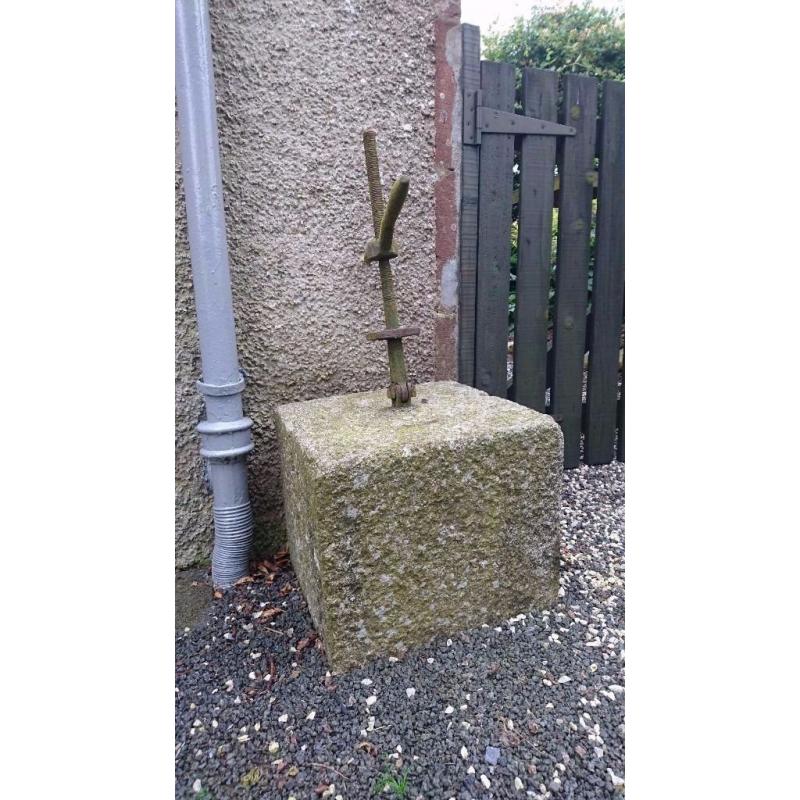 A large piece of dressed granite, part of a cheese press