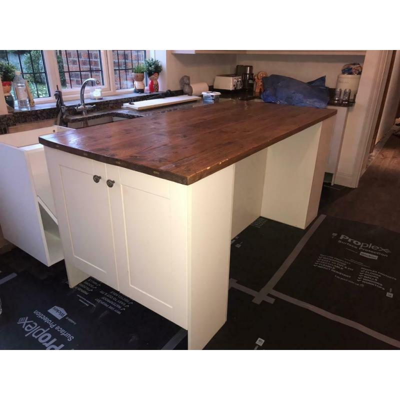 Cream shaker style kitchen island with cupboards and solid wood top